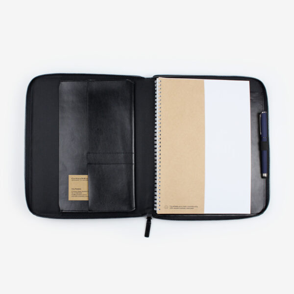 Open black A4 leather compendium with internal pockets and pen loop.